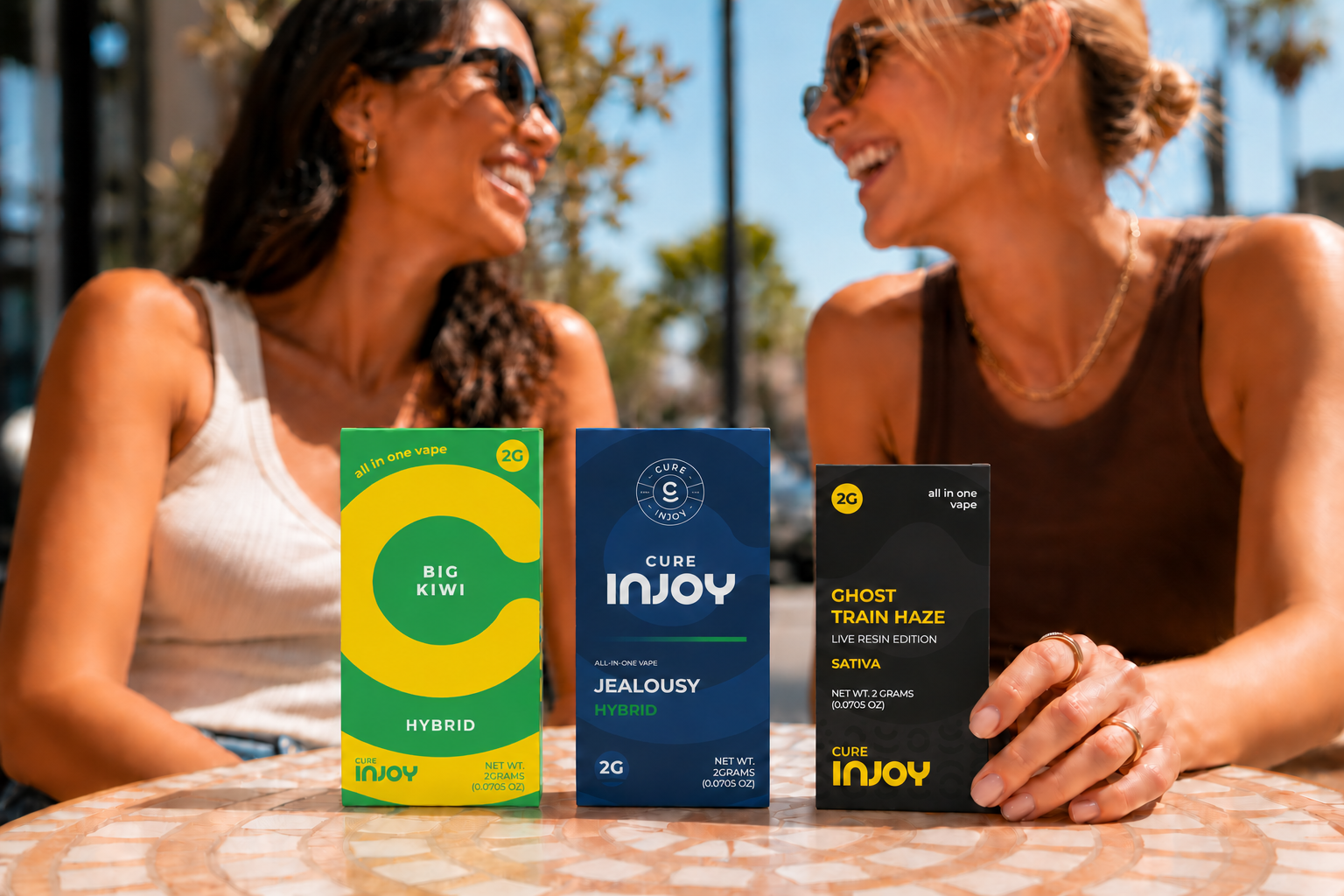 Cure Injoy Essentials, Legacy, and Live Resin boxes, with Big Kiwi correctly labeled Hybrid